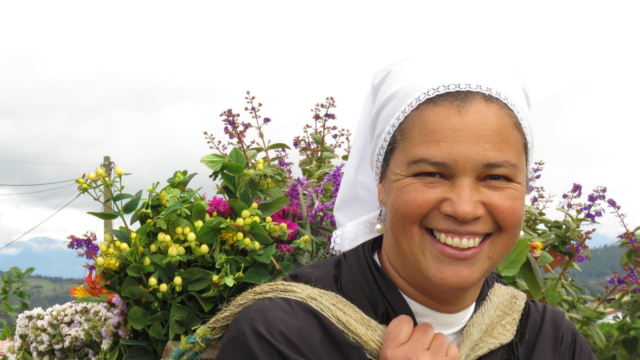 A silletera from Santa Elena carrying a traditional flower silleta during Feria de las Flores